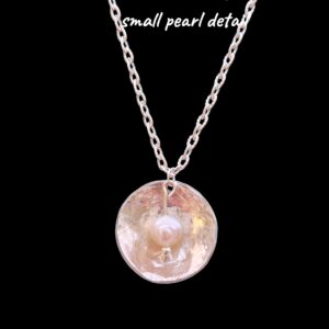 Necklace - Hand hammered silver disc with small pearl detail.